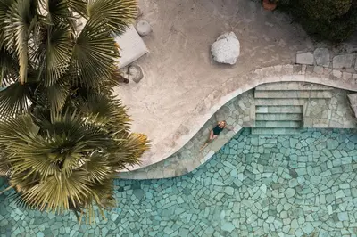 an overhead view of a man in a swimming pool at Lake Spa Hotel SEELEITEN in Caldaro