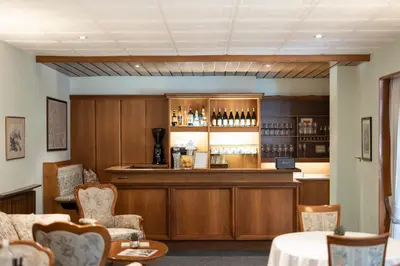 a bar in a restaurant with a counter and chairs at Weingarten Terlan - Rooms & Breakfast in Terlano