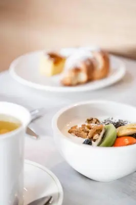 a bowl of food and a cup of coffee on a table at Hotel Ambet in Maranza