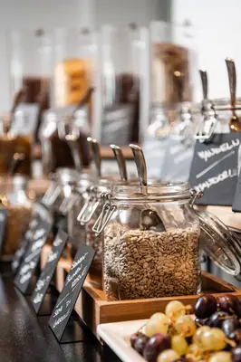 a display of food in jars on a table at Hotel Ambet in Maranza