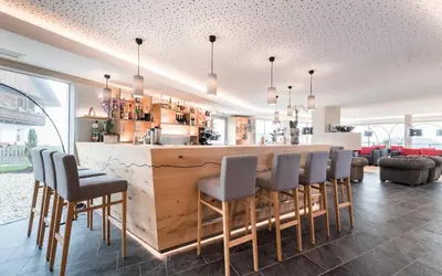 a bar with chairs and a counter in a room at Hotel Ambet in Maranza