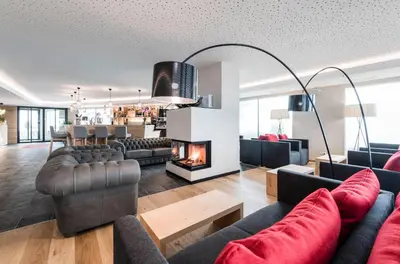 a living room with couches and a fireplace at Hotel Ambet in Maranza