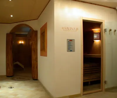 a hallway with a door leading into a room at Hotel San Martino in San Martino di Castrozza