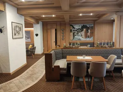 a dining room with a table and chairs at Hotel San Martino in San Martino di Castrozza