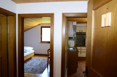 a small room with a bedroom and a kitchen at Residence Granvara in Ortisei