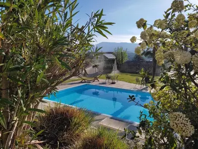 a swimming pool in a yard with trees at Garni Brunnenhof in Caldaro