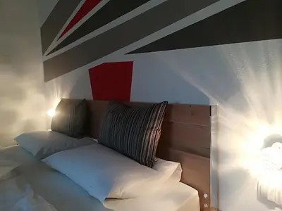 a bed with two pillows on it in a room at Garni Brunnenhof in Caldaro