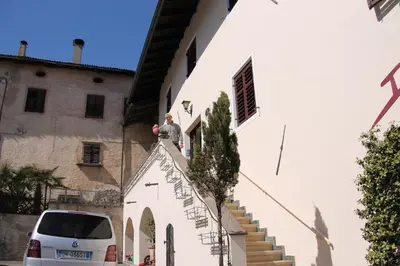 a man standing on the roof of a building at Garni Brunnenhof in Caldaro