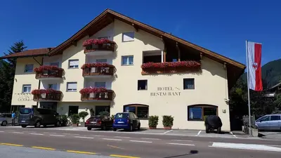 a large building with flower boxes on the side of it at Hotel Klammer in Vipiteno
