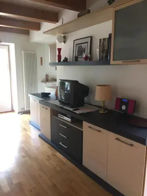 a kitchen with a counter with a microwave and a television at Lausen Vil in Canale San Bovo
