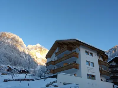 a hotel in the mountains with snow on the ground at Garnì La Dorada in Colfosco