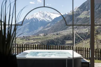 a bath tub with a view of a mountain at Hotel Erzherzog Johann in Schenna