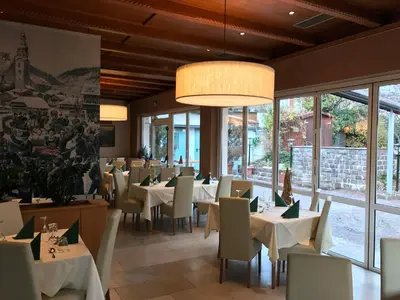 a dining room with tables with white tablecloths at Hotel Zum Turm in Castelrotto