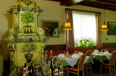 a dining room with two tables and a large mirror at Hotel Zum Turm in Castelrotto