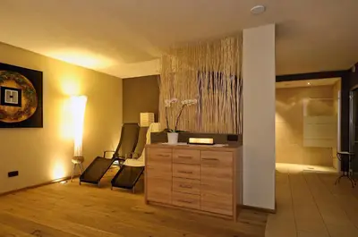 a room with a dresser and a room with a bathroom at Residence Ciasa Mirasas in Badia