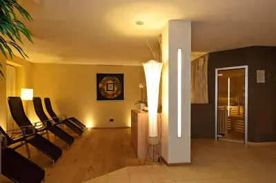 a living room with black and yellow walls and chairs at Residence Ciasa Mirasas in Badia