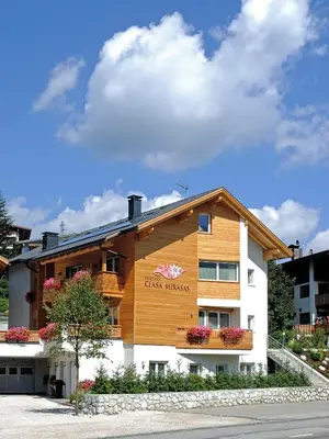 a building with a sign on the side of it at Residence Ciasa Mirasas in Badia
