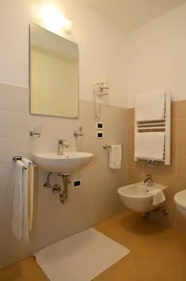 a bathroom with a sink and a mirror at Residence Ciasa Mirasas in Badia