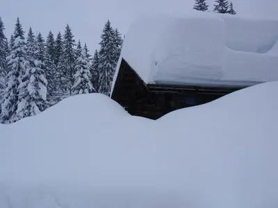 two piles of snow on the roof of a building at Pensione Vittoria in Colfosco