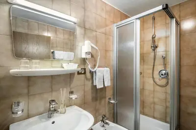 a bathroom with a sink and a shower at Pensione Vittoria in Colfosco