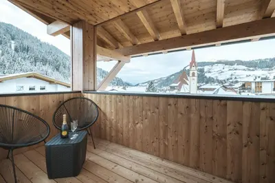a balcony with a view of a church at Apartment Villa Stefania in Selva di Val Gardena