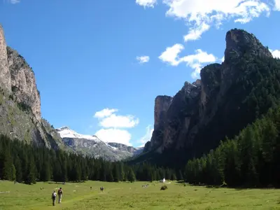 a group of people in a field in the mountains at Apartment Villa Stefania in Selva di Val Gardena