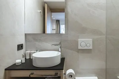 a bathroom with a white sink and a mirror at Apartment Villa Stefania in Selva di Val Gardena