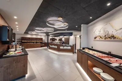 a restaurant with a buffet line with dishes on display at Hotel Edelweiss in Maranza