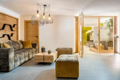 a living room with a couch and a table at Hotel Erika in Braies
