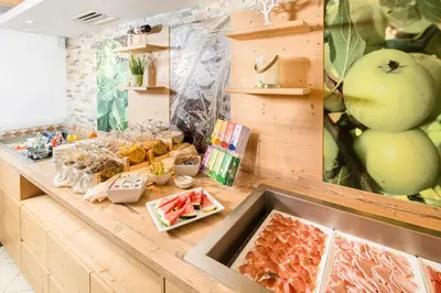 a kitchen counter with fruits and vegetables on it at Hotel Erika in Braies