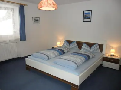 a bedroom with a bed with blue and white pillows at Maurerhof Telves in Racines