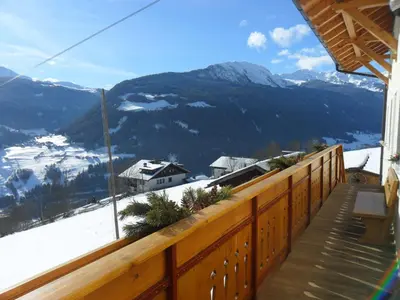 a balcony with a view of a snow covered mountain at Maurerhof Telves in Racines