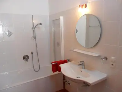 a bathroom with a sink and a shower and a mirror at Maurerhof Telves in Racines