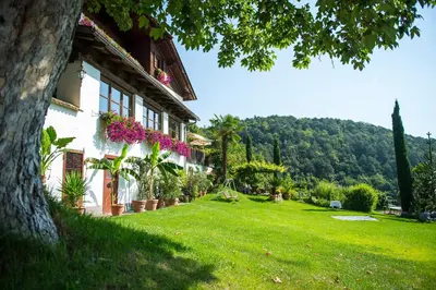 a house with flowers on the side of a yard at Gasthof Wieser in Appiano sulla Strada del Vino