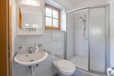 a bathroom with a sink and a toilet and a shower at Gasthof Falkenstein in Naturno