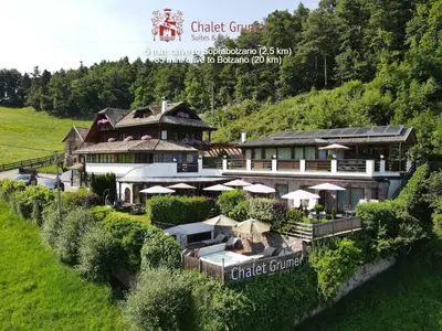an aerial view of a building with a lawn at Chalet Grumer Suites&Spa in Soprabolzano