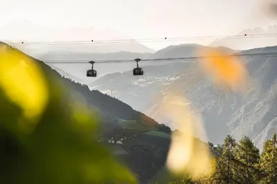 a ski lift with a view of a mountain at Chalet Grumer Suites&Spa in Soprabolzano