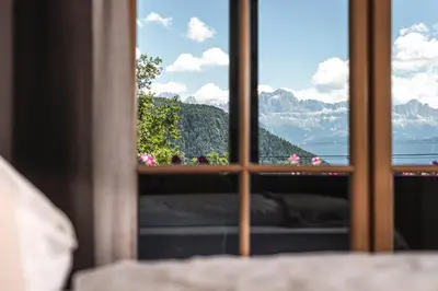 a window with a view of a mountain view at Chalet Grumer Suites&Spa in Soprabolzano