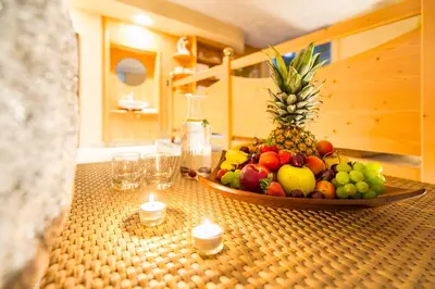 a bowl of fruit sitting on a counter with candles at Hotel Verena in Lana
