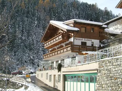 a building with a balcony on top of it in the snow at Residence Talblick in San Leonardo in Passiria