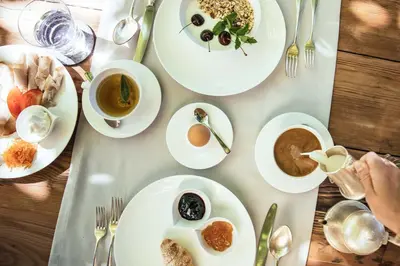 a table with plates of food and cups of coffee at Tirolerhof in San Leonardo in Passiria