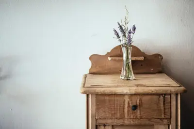 a vase of flowers sitting on top of a wooden table at Tirolerhof in San Leonardo in Passiria