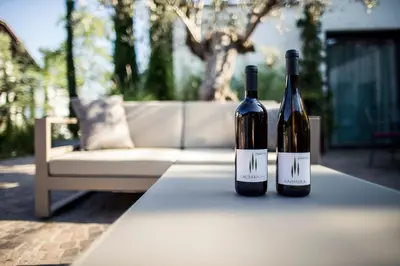 two bottles of wine sitting on top of a table at Felderer Boutiquehotel B&B in Caldaro