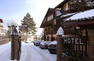 a large house with snow in front of it at Park Hotel Villa Trunka Lunka in Cavalese