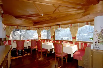 a wooden building with a balcony on top of it at Park Hotel Villa Trunka Lunka in Cavalese