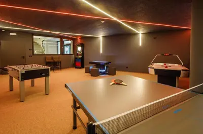 a room with a ping pong table and pool tables at Hotel Panorama in Schenna