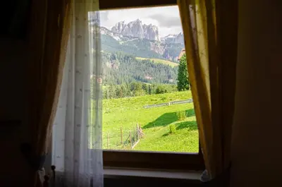 a window with a view of a mountain at Kyrr Smart Mountain Retreat in Moena