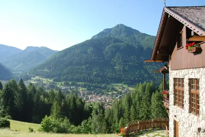 a house on a hill with a view of a valley at Kyrr Smart Mountain Retreat in Moena