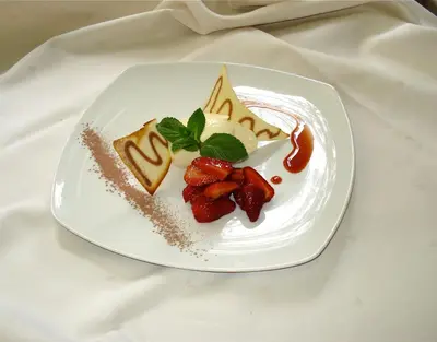 a plate of food with meat and vegetables on a table at Hotel San Leonardo in Badia