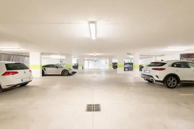 a parking garage with several cars parked in it at Hotel Garni Nachtigall in Schenna